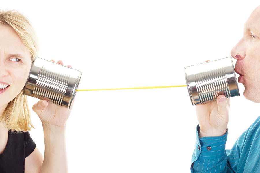 Two people communicating through a tin can phone