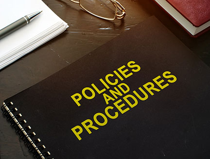 Policies and procedures company documents on a desk