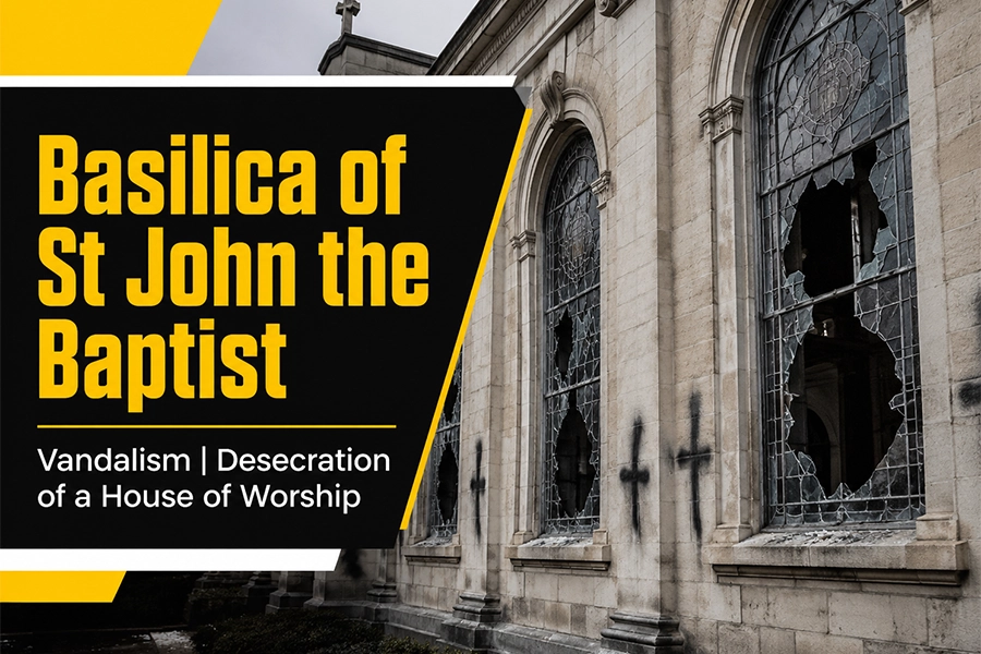 A landscape article image showing a historic church exterior with broken stained-glass windows, dark vandalism marks, and bold black, yellow, and white text reading “Basilica of St John the Baptist Vandalism | Desecration of a House of Worship.”