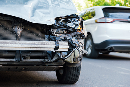 Destroyed car in car crash traffic accident on city road