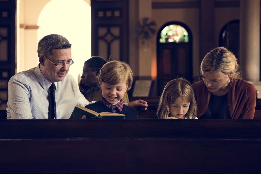 Family sitting in pew at church