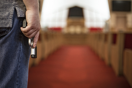 man holding a gun in a church