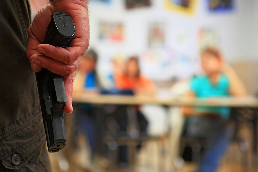 Man with a gun in a classroom