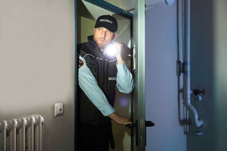 Security guard checking dark room