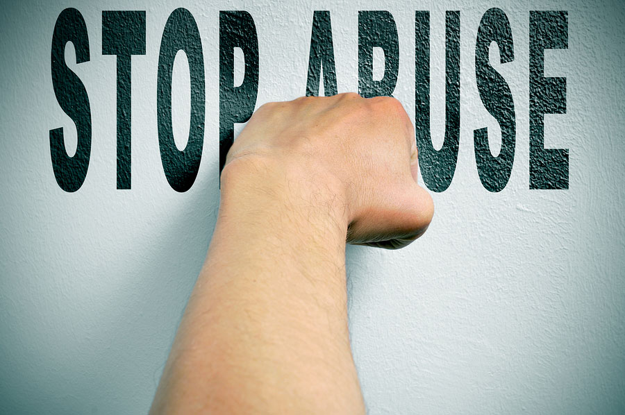 a man punching the text stop abuse, depicting the concept of the fight against all kind of abuse, such as domestic abuse or child abuse