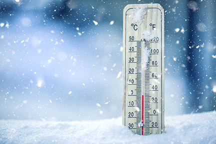 Thermometer on snow shows low temperatures and cold winter weather