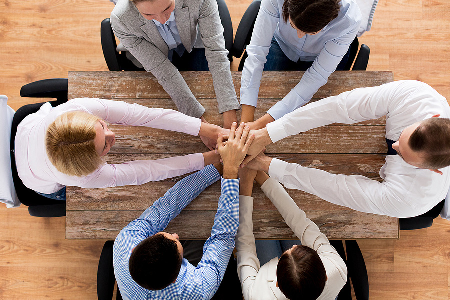 team members with hands together in a huddle